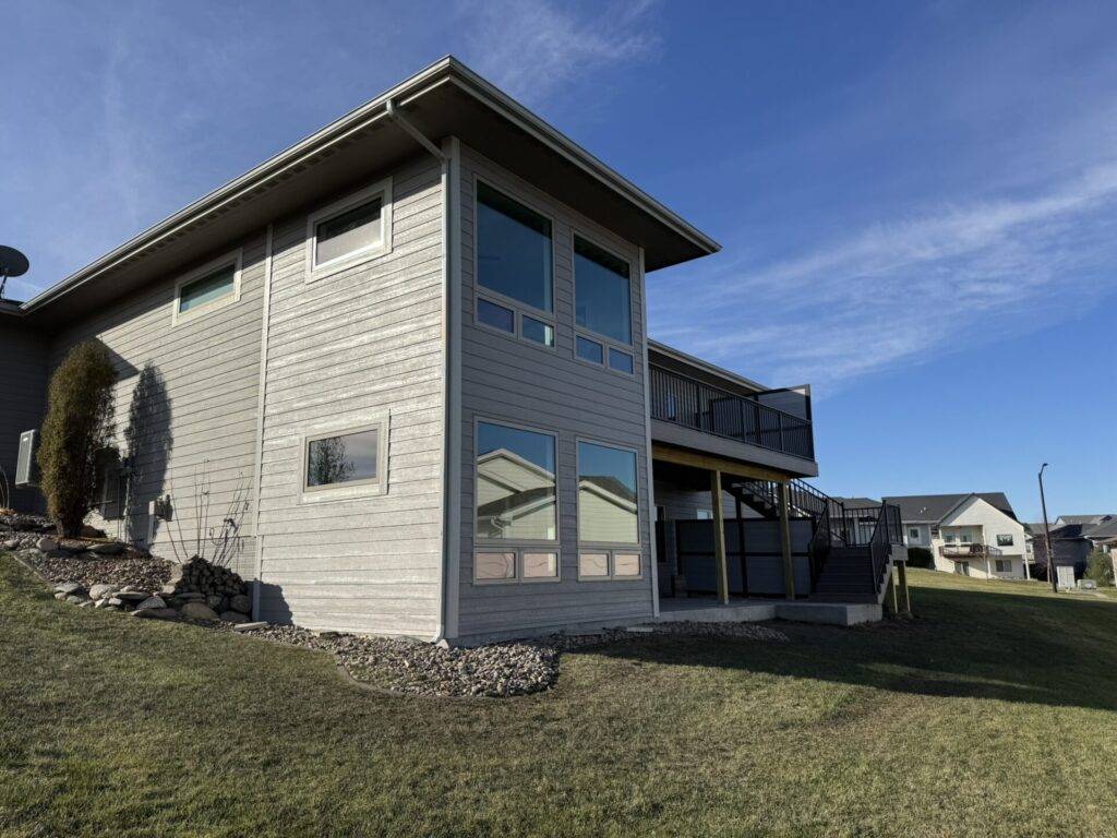 Finished two story home exterior with modern windows and rear deck in Central Iowa