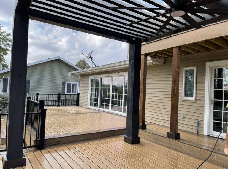 Composite deck with a pergola shade structure attached to a Central Iowa home