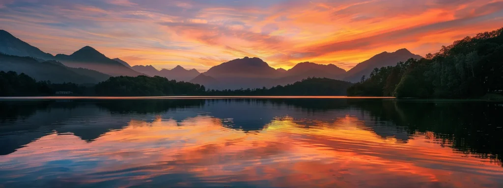 Successful Interior Remodeling Starts with Busy Builders 2 a breathtaking sunset casts vibrant hues of orange and pink across a tranquil lake, reflecting the serene silhouettes of towering mountains in the distance.
