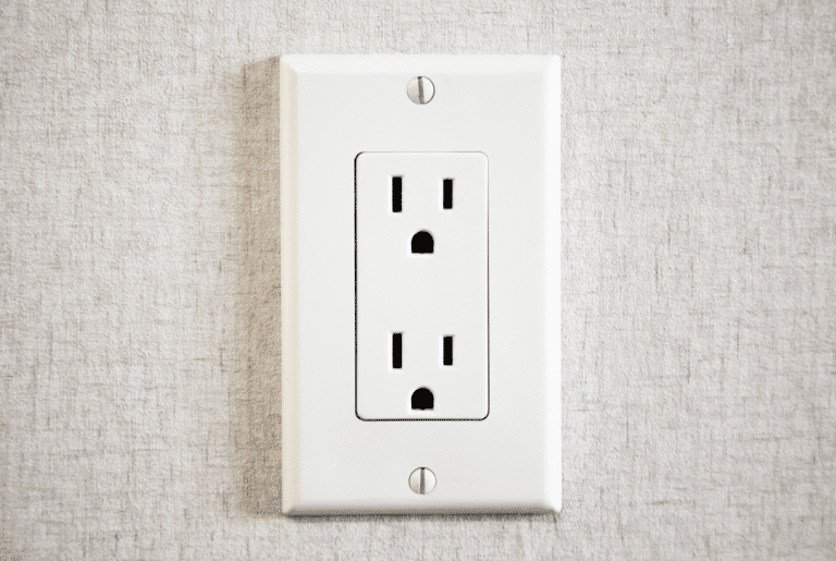 standard duplex electrical outlet on a textured white wall