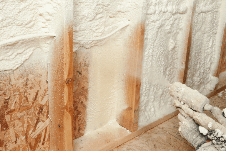 closed-cell spray foam insulation applied between wood stud framing cavities for air sealing and thermal performance in residential construction