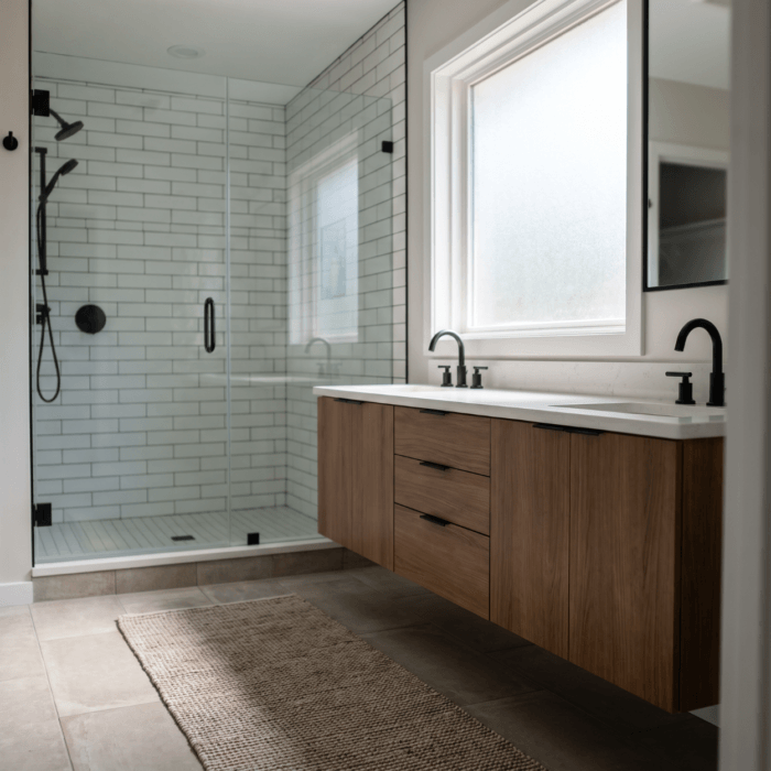 Modern bathroom remodel with glass walk-in shower and floating vanity in a Waukee Iowa home