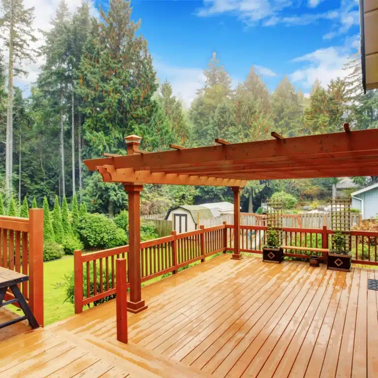 Busy Builders crew installing deck railings on a new backyard deck in Ames, Iowa